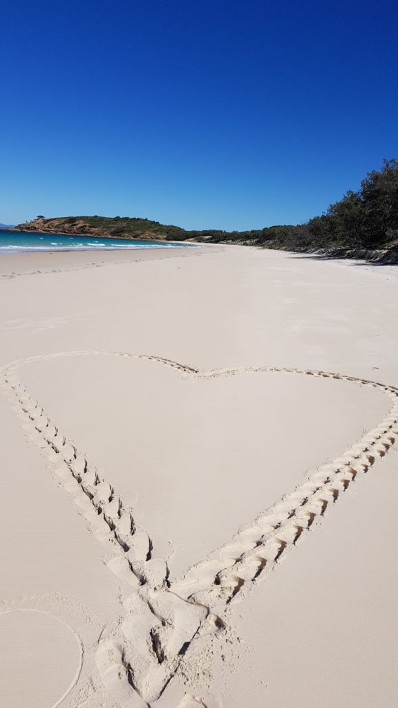 heart in sand long beach keppel island australia